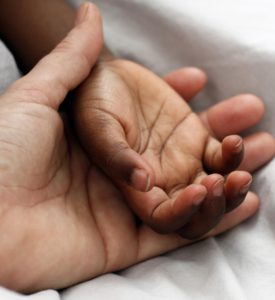 Parent holding child's hand