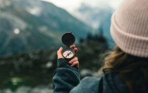 Person holding a compass with confidence after gaining legal clarity from The Chariot Law Firm