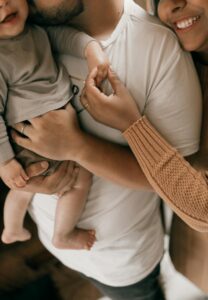 Family smiling together after completing adoption process
