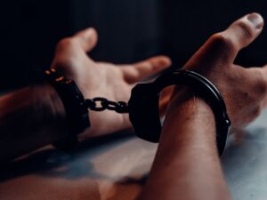 Person in legal custody and handcuffs