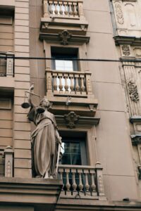 Balanced justice scales on the outside of a courthouse