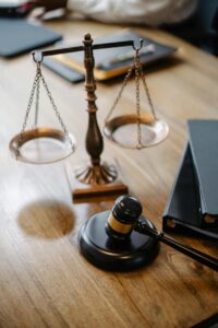 Scales of justice on desk with law books in background